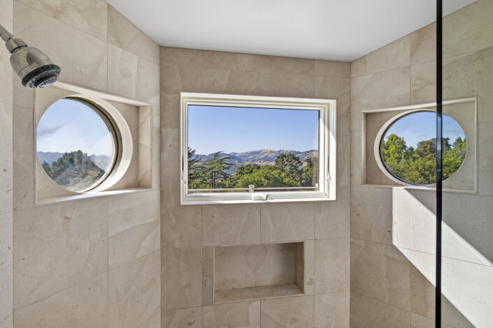 View of hills through window inside shower