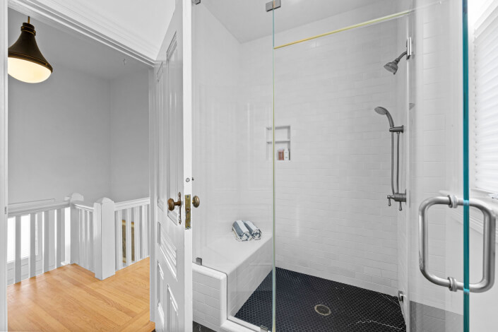 Shower with glass surround and tile bench