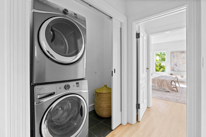 Laundry machines stacked in closet