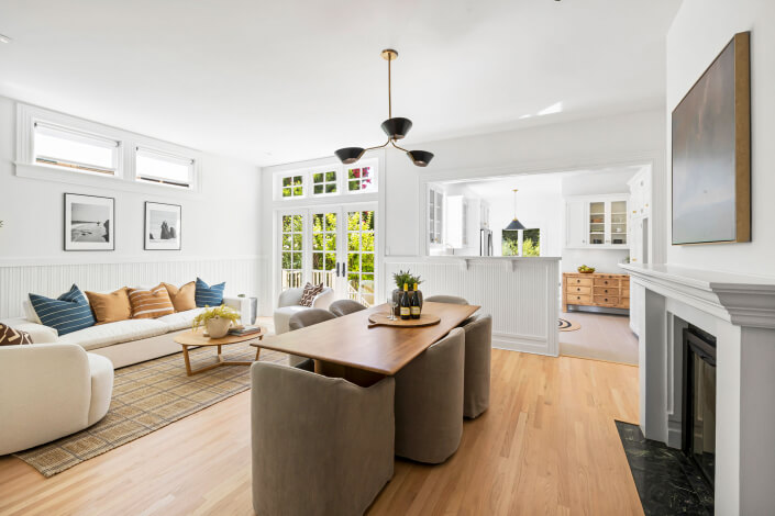 Family room with sofa and fireplace and kitchen in distance