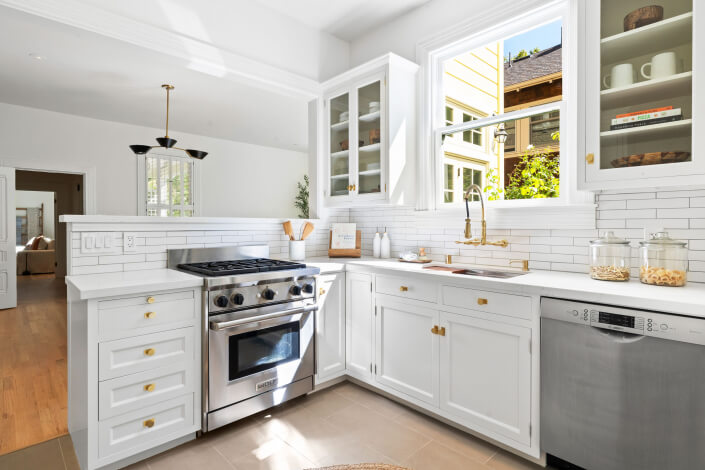 Kitchen with stainless appliances and tile backsplash and open shelving