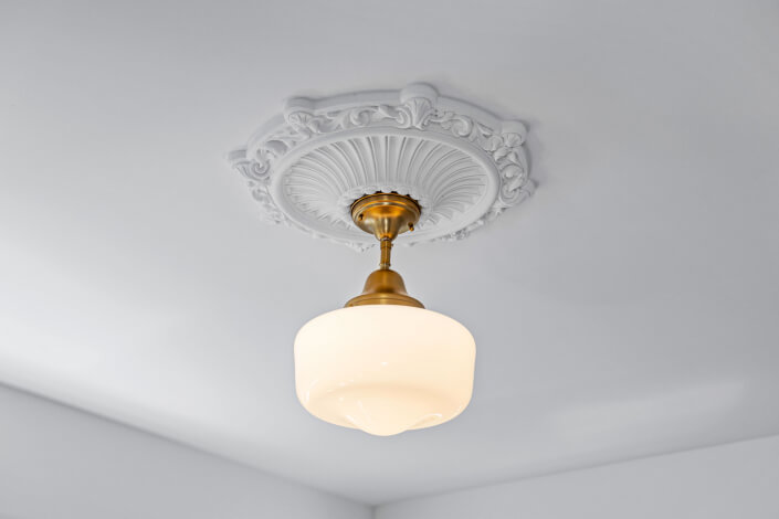 Antique looking light fixture with ceiling medallion