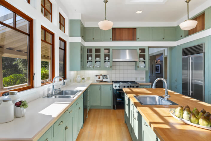 Kitchen with pale green cabinetry