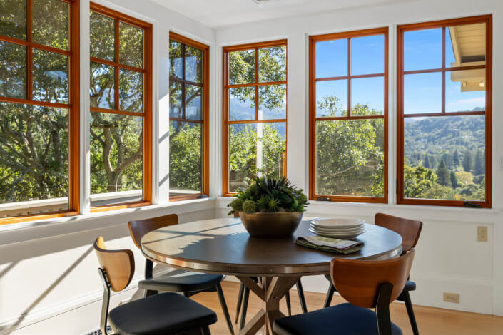 Corner kitchen table with windows looking out to mountains