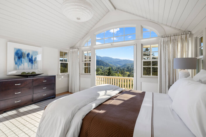 Primary bedroom with view out to deck