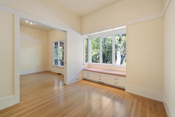 Room with hardwood floors and window seat