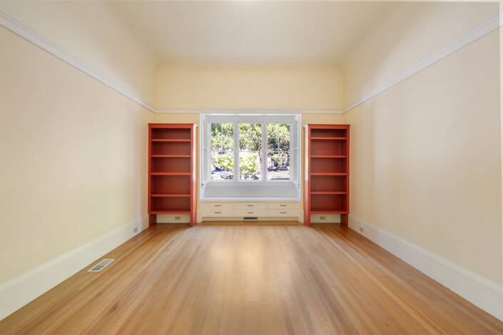 Room with two bookshelves and hardwood floors