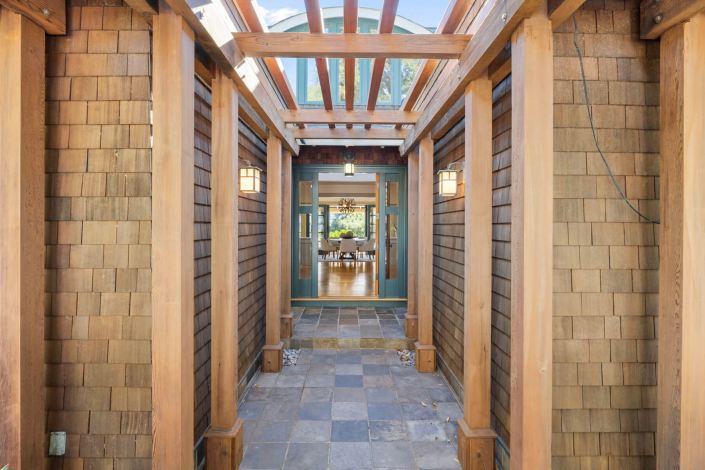 Entryway outside with shingles and columns